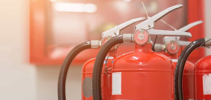 Three large red fire extinguishers